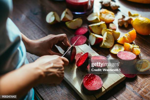 woman's hands chopping beetroot for squeezing juice - orange apple lemon stock pictures, royalty-free photos & images