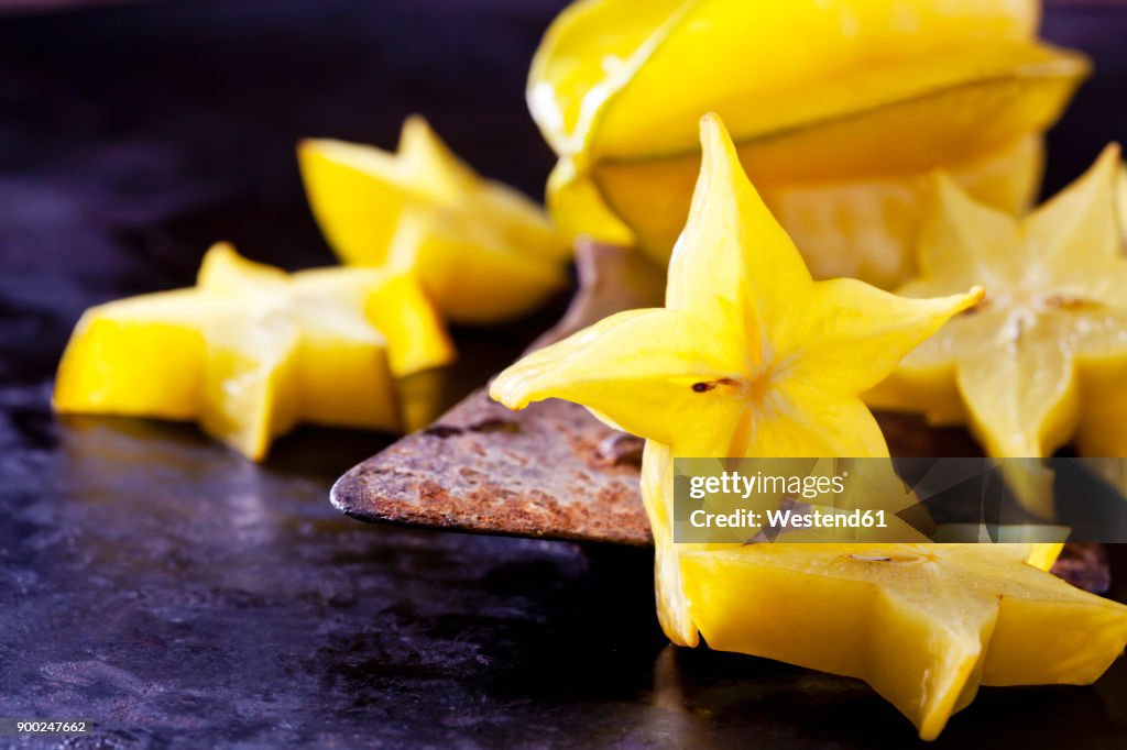 Sliced starfruit on an old cleaver