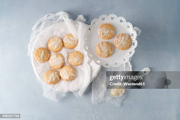 biscuits with sugar icing and coconut flakes - doily stock pictures, royalty-free photos & images