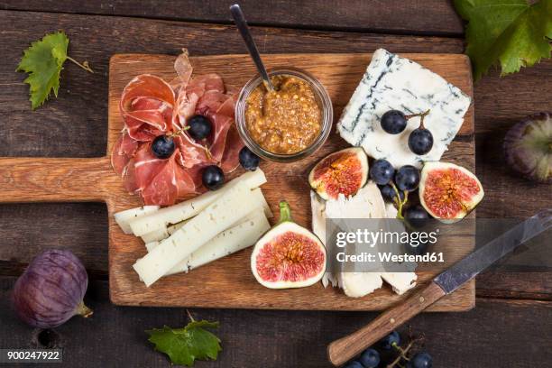 cheese platter with fruits and fig mustard - cheese plate stock-fotos und bilder