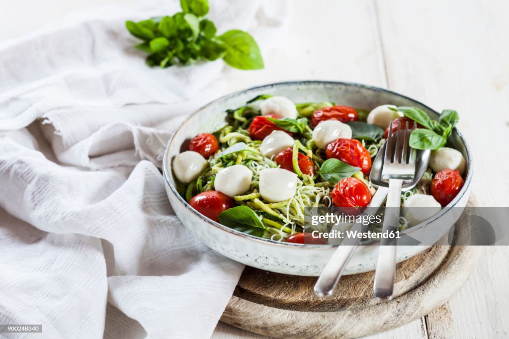 Zoodles Caprese, spiralized zucchini, glass noodles, pesto, plum tomatoe, mozarella balls
