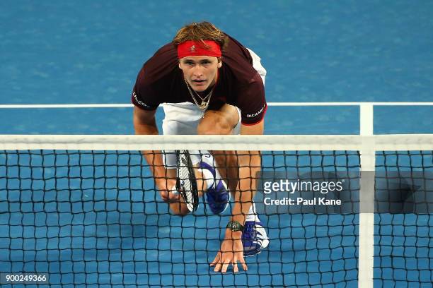 Alexander Zverev of Germany prepares for the serve from Angelique Kerber in the mixed doubles match against Elise Mertens and David Goffin of Belgium...