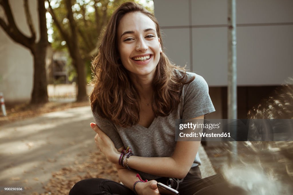 Portrait of happy young woman outdoors