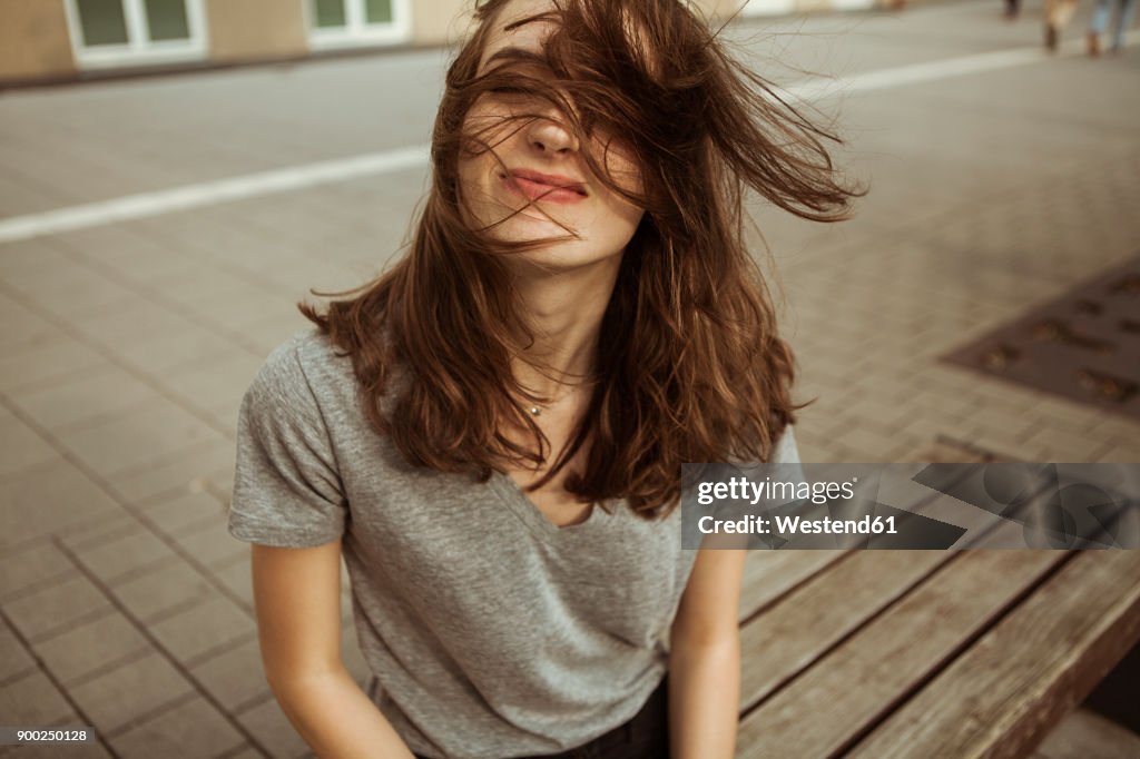 Young woman outdoors with windswept hair