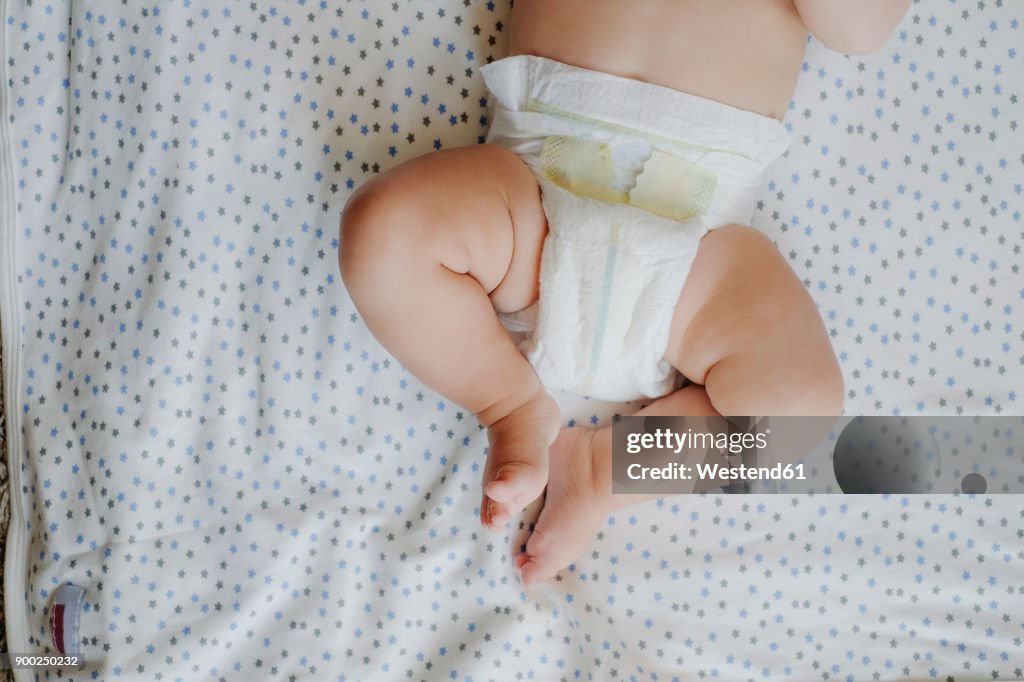 Baby boy wearing diapers, partial view