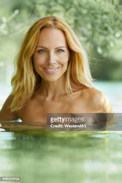 portrait of smiling blond woman bathing in lake - beautiful bare women stock pictures, royalty-free photos & images