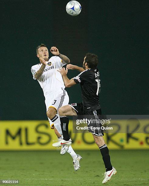 Ben Olsen of D.C. United goes up for a header with David Beckham of the Los Angeles Galaxy during an MLS match at RFK Stadium on August 22, 2009 in...