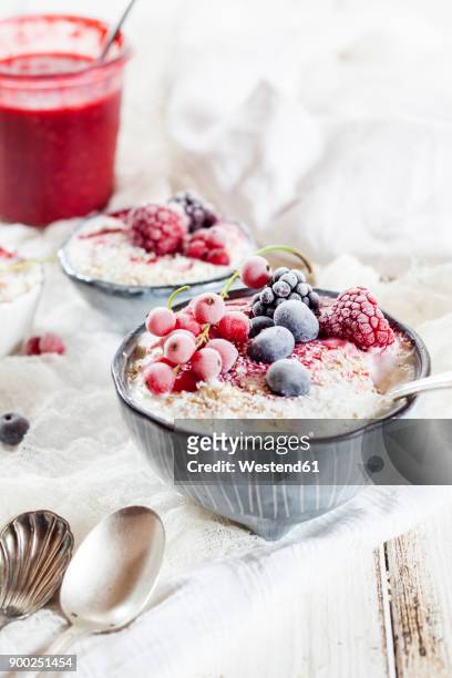 bowl of natural yoghurt with raspberry sauce and frozen fruits - raspberry coulis stock pictures, royalty-free photos & images