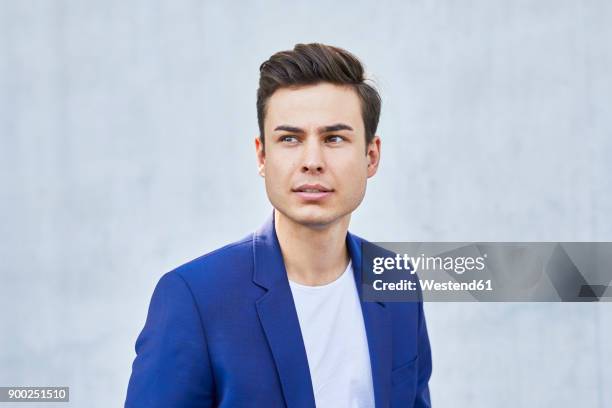 portrait of young man wearing blue jacket - jacket fotografías e imágenes de stock