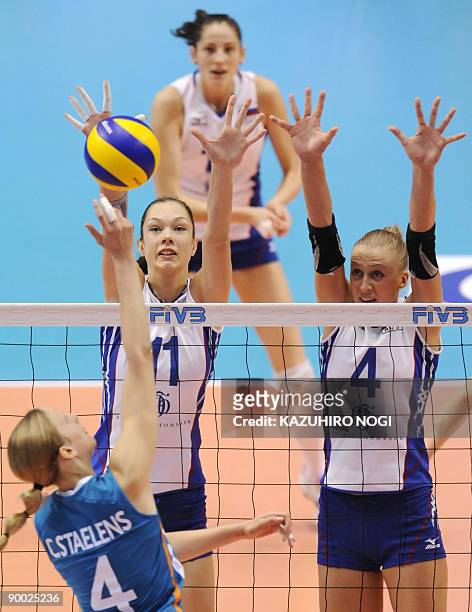 Russia's Ekaterina Gamova and Elena Murtazaeva try to block a spike from Chaine Staelens of the Netherlands during a final round match of the World...