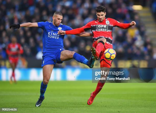 Islam Slimani of Leicester City challenges Christopher Schindler of Huddersfield Town during the Premier League match between Leicester City and...
