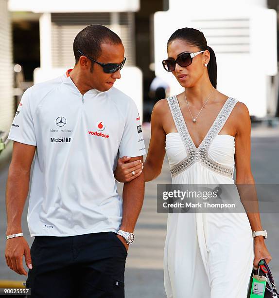 Lewis Hamilton of Great Britain and McLaren Mercedes and his girlfriend Nicole Scherzinger of the Pussycat Dolls walk in the paddock before the...