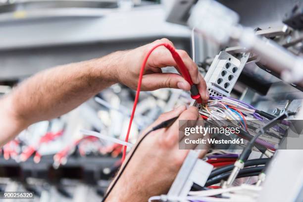close-up of man using voltmeter in factory - voltmeter stock pictures, royalty-free photos & images