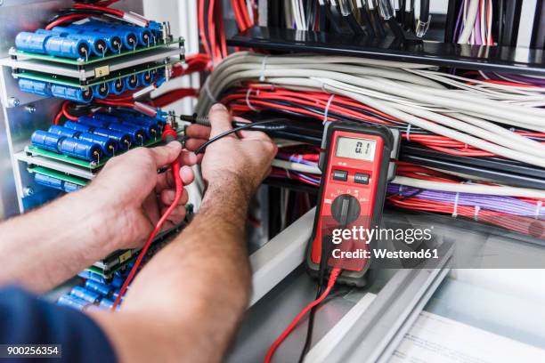 close-up of man using voltmeter in factory - voltmeter stock pictures, royalty-free photos & images