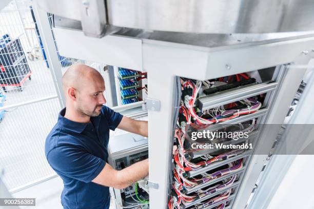 man using voltmeter in modern factory - voltmeter stock pictures, royalty-free photos & images