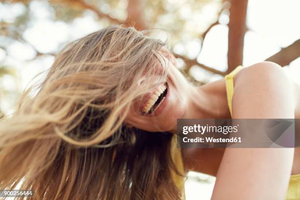 portrait of laughing young woman with blowing hair - summer beauty woman stock pictures, royalty-free photos & images