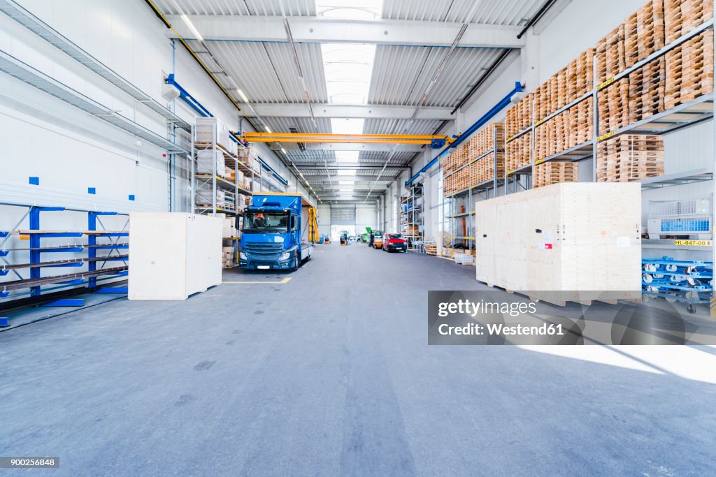 Factory hall with truck and pallets