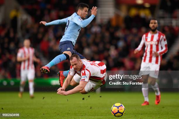 Javi Manquillo of Newcastle United collide with Charlie Adam of Stoke City during the Premier League match between Stoke City and Newcastle United at...