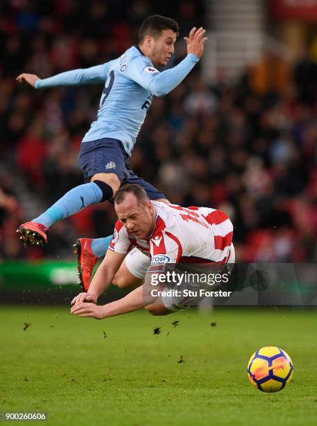 Javi Manquillo of Newcastle United collide with Charlie Adam of Stoke City during the Premier League match between Stoke City and Newcastle United at...