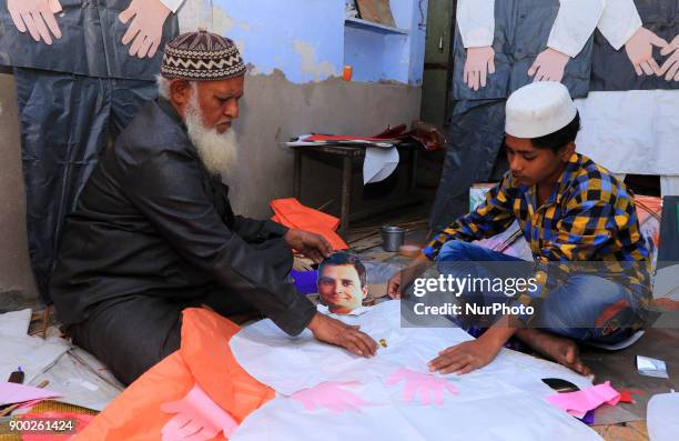An Indian Kitemaker Abdul Gaffur gives a final touch to his kites made from the cut out of Main Opposition Party 'Congress' President Rahul Gandhi...