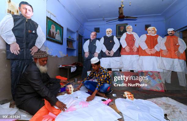 An Indian Kitemaker Abdul Gaffur gives a final touch to his kites made from the cut out of Main Opposition Party 'Congress' President Rahul Gandhi...