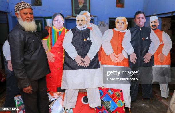 An Indian Kitemaker Abdul Gaffur gives a final touch to his kites made from the cut out of Indian Politicians ahead of Hindu festival Makar Sakranti...