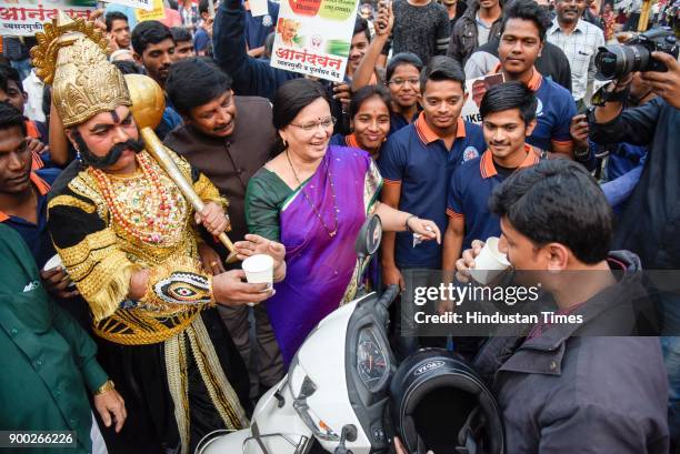 Mayor Mukta Tilak and a man dressed as Yamraj and students of MMCC college offering milk to commuters on New Years eve at Goodluck chowk, on December...