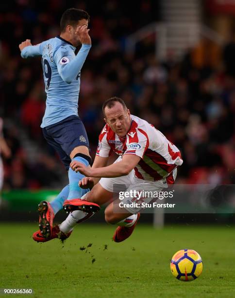 Javi Manquillo of Newcastle United fouls Charlie Adam of Stoke City during the Premier League match between Stoke City and Newcastle United at Bet365...