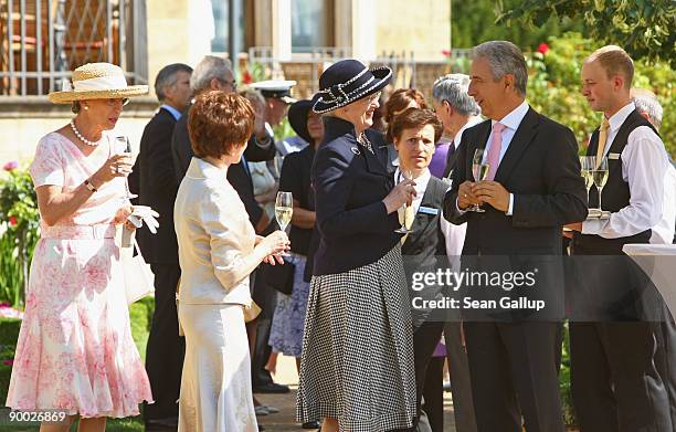 Saxony Governor Stanislaw Tillich chats with Queen Margrethe II of Denmark as her sister Danish Princess Benedikte and Tliich's wife Veronika look on...