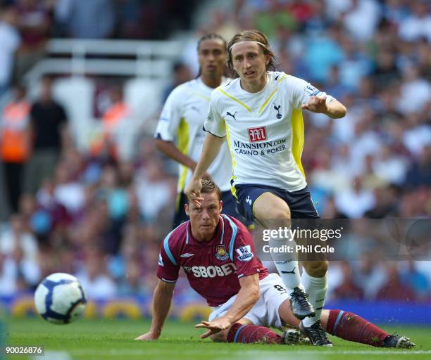 Scott Parker of West Ham United tackles Luka Modric of Tottenham Hotspur during the Barclays Premier League match between West Ham United and...