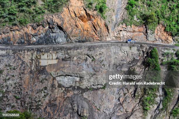 narrow street in cliff with trucks, death road, camino de la muerte, yungas road between la paz and coroico, bolivia - yungas stock pictures, royalty-free photos & images
