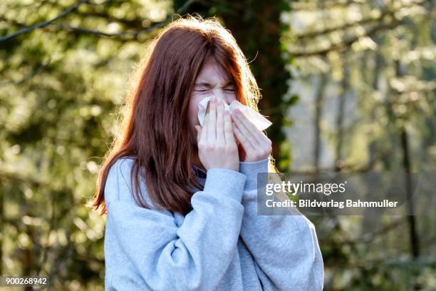 teenager, girl wiping her nose, runny nose, allergy, germany - snorted stock pictures, royalty-free photos & images