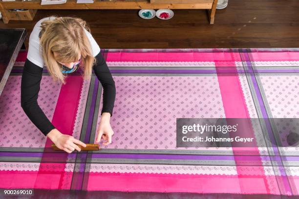 block printing, woman pressing woodblock with paint on fabric, bad aussee, styria, austria - bad aussee stock pictures, royalty-free photos & images