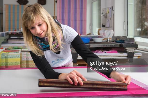 block printing, woman positioning woodblock with paint on taut fabric panel, bad aussee, styria, austria - bad aussee stock pictures, royalty-free photos & images