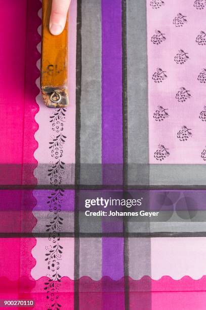block printing, hand pressing woodblock with pattern and color on fabric, bad aussee, styria, austria - bad aussee stock pictures, royalty-free photos & images
