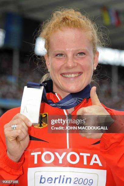 Germany's Betty Heidler celebrates during the women's hammer throw medal ceremony of the 2009 IAAF Athletics World Championships on August 23, 2009...