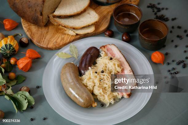 bavarian specialty, meat platter with sausage, black pudding and wammerl with sauerkraut, bavaria, germany - black pudding stock pictures, royalty-free photos & images