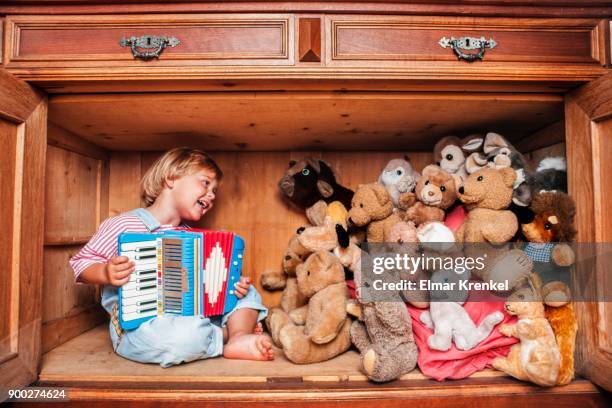 five year old girl playing accordion for her stuffed animals, tyrol, austria - accordéon photos et images de collection