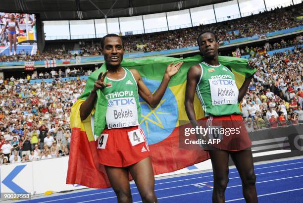 Ethiopia's Kenenisa Bekele and Ethiopia's Ali Abdosh celebrate after the men's 5000m race of the 2009 IAAF Athletics World Championships on August...