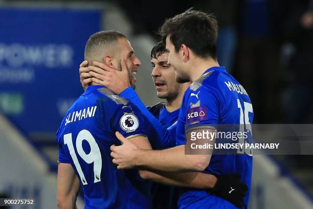 Leicester City's Algerian striker Islam Slimani celebrates scoring the team's second goal, with teammates during the English Premier League football...