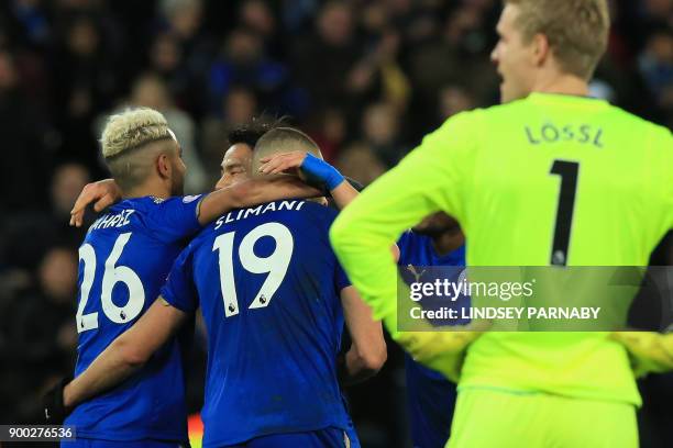 Leicester City's Algerian striker Islam Slimani celebrates scoring the team's second goal, with Leicester City's Algerian midfielder Riyad Mahrez as...