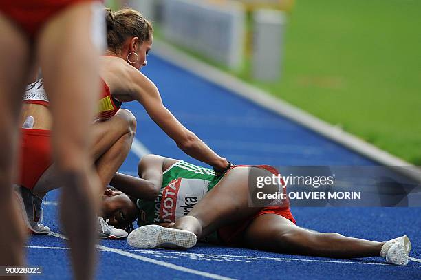 Spain's Natalia Rodriguez conforts Ethiopia's Gelete Burka after the women's 1500m final of the 2009 IAAF Athletics World Championships on August 23,...