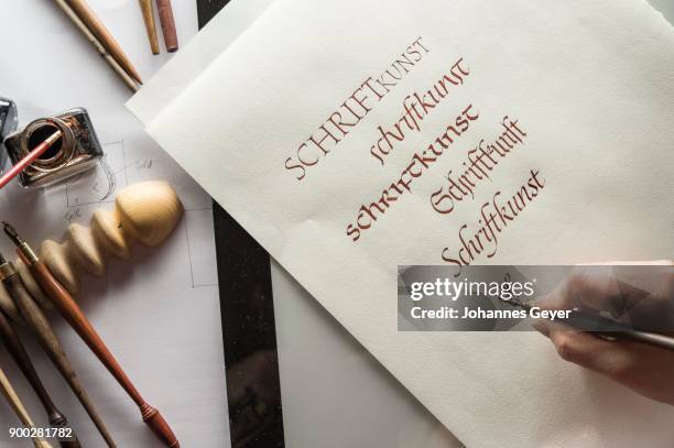 calligraphy studio, hand writes text with ink pen and nib, anglaise writing on ingres paper, inkwell and pen holder at back, seebruck, upper bavaria, germany - ingres stock pictures, royalty-free photos & images