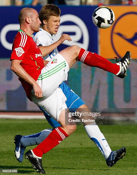 Maksim Kanunnikov of FC Zenit St. Petersburg battles for the ball with Malkhaz Asatiani of FC Lokomotiv Moscow during the Russian Football League...