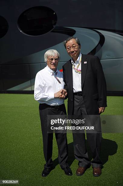 Formula 1 boss Bernie Ecclestone shakes hand with the President of Mobilityland Corporation, Hiroshi Oshima, after they signed a contract which will...