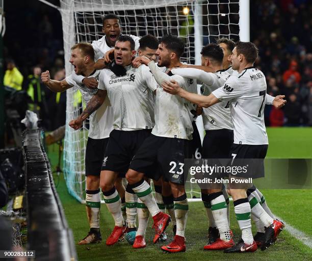 Ragnar Klavan of Liverpool celebrates with his team mates after scoring the winning goal during the Premier League match between Burnley and...