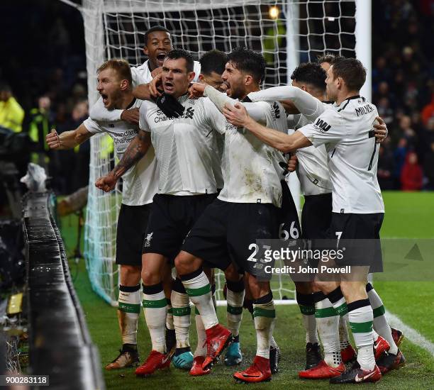 Ragnar Klavan of Liverpool celebrates with his team mates after scoring the winning goal during the Premier League match between Burnley and...