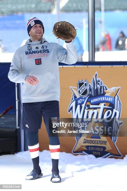 Steven Kampfer of the New York Rangers throws a baseball prior to warm ups during the 2018 Bridgestone NHL Winter Classic against the Buffalo Sabres...