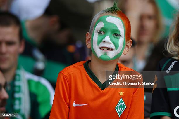 Young supporter of Bremen looks on during the Bundesliga match between Werder Bremen and Borussia Moenchengladbach at the Weser Stadium on August 23,...