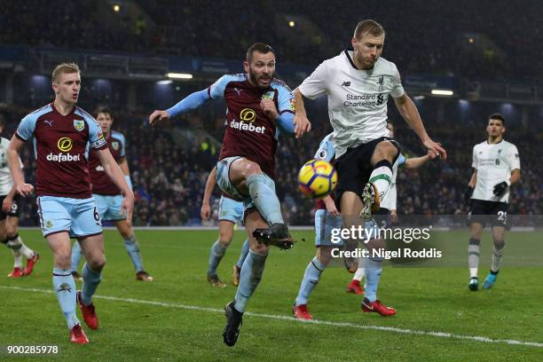 Ragnar Klavan of Liverpool shoots while under pressure from Phil Bardsley of Burnley during the Premier League match between Burnley and Liverpool at...